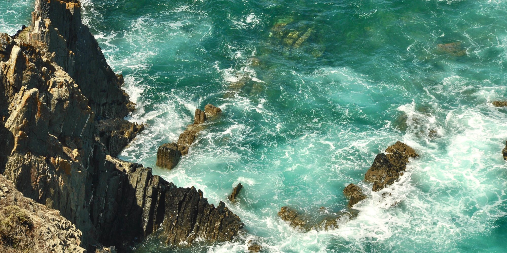 Waves crashing against the rocks in Santiago do Cacém.jpg